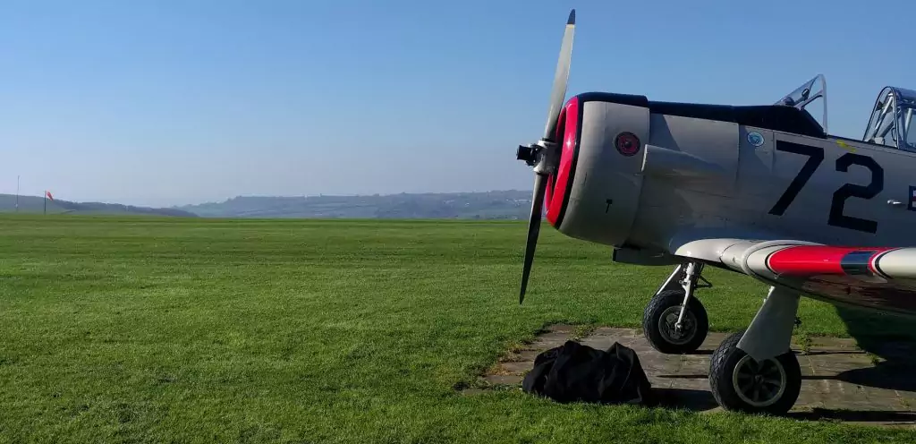 A Harvard in a US Marines in livery with the runway and hills in the background